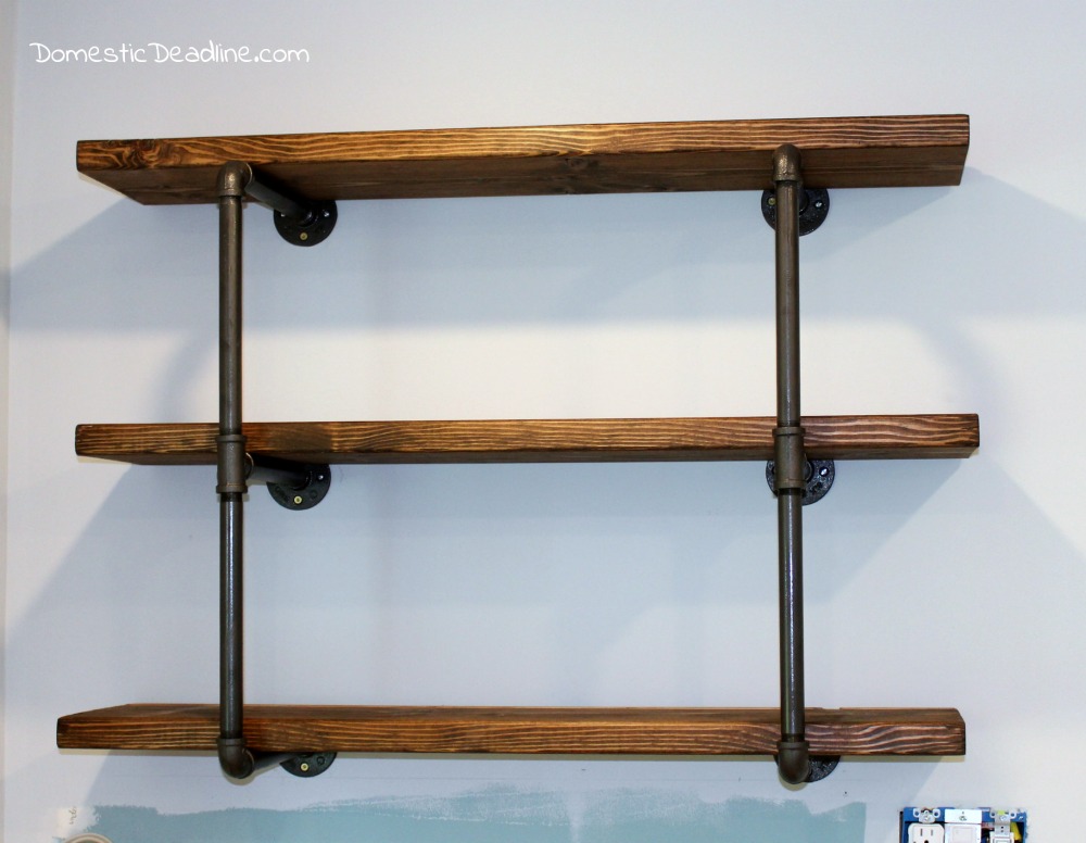 Using iron pipe, thick wood planks, spray paint and stain, I created the perfect industrial shelving for my DIY farmhouse kitchen. I'll show you how on Domestic Deadline