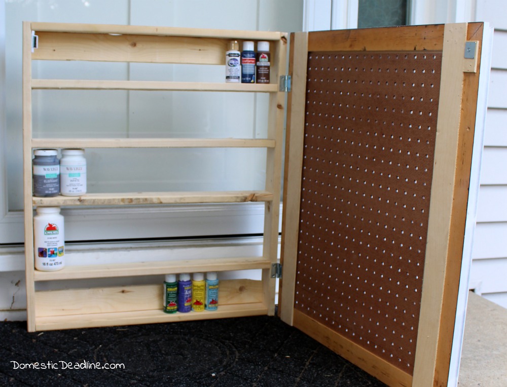 Using an old frame, a piece of pegboard and some scrap lumber I'll show you how I created a cabinet to store paint and organize craft supplies - Domestic Deadline