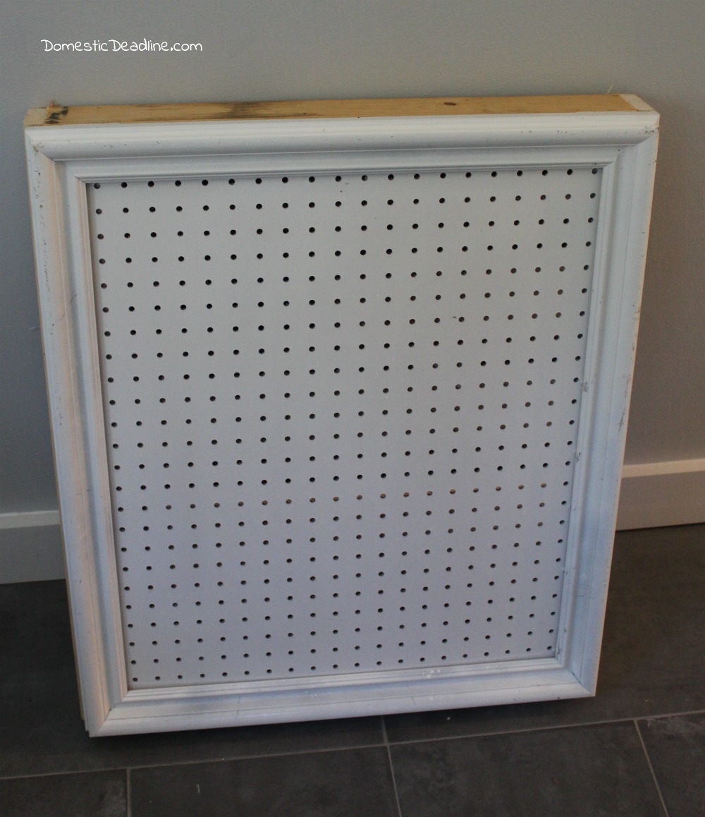 Using an old frame, a piece of pegboard and some scrap lumber I'll show you how I created a cabinet to store paint and organize craft supplies - Domestic Deadline