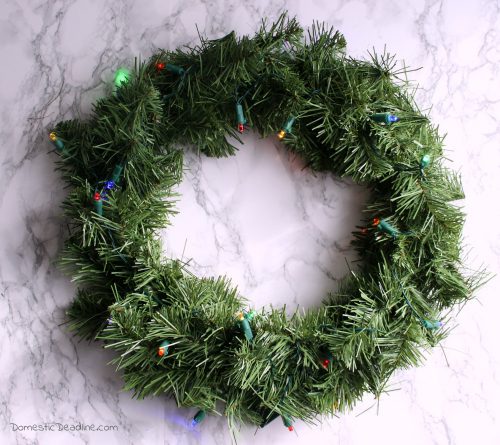 Multiple light up wreaths with battery operated timers to add a festive glow. The 12 Days of Christmas Blog Hop provides even more ideas. - Domestic Deadline