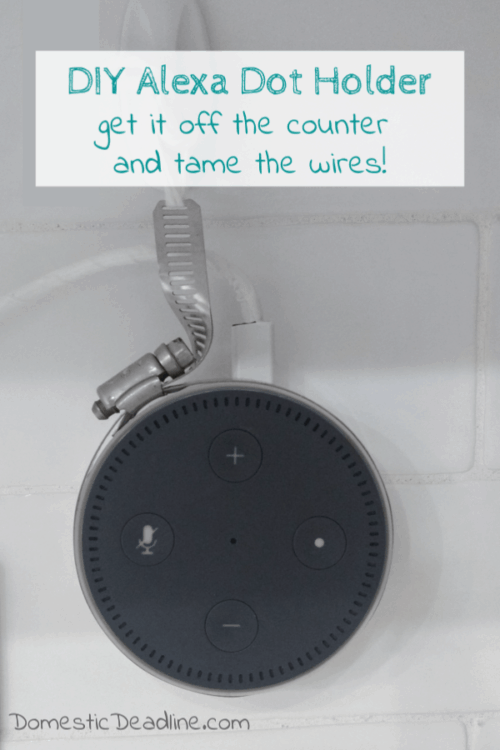 An easy and inexpensive way to hang your Amazon Alexa Dot on the wall near the outlet. This DIY Alexa Dot Holder uses a hose clamp and command hooks. Upcycle Challenge www.domesticdeadline.com