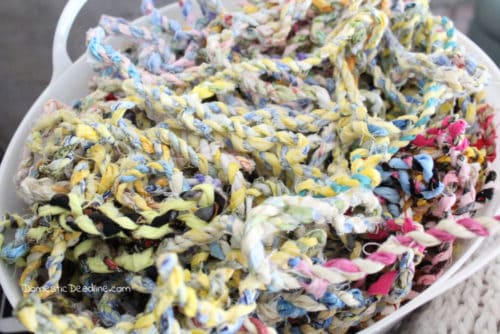 Strips of scrap fabric easily turns into colorful twine to use for wrapping gifts or other craft projects. Fun and easy way to destash your scrap fabric pile. www.domesticdeadline.com