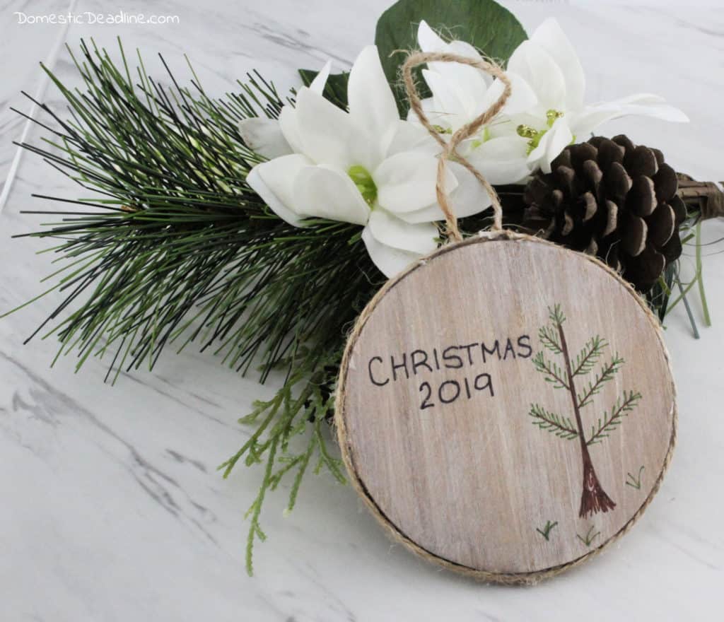 Learn how easy it is to make a custom rustic ornament celebrating your family traditions for the Christmas season. Family traditions are even more special at Christmas time. DomesticDeadline.com