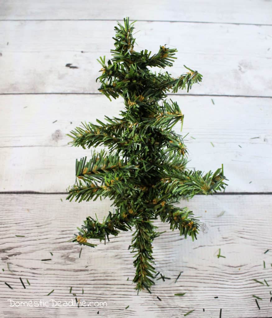 Learn how to make mini burlap wrapped trees with dollar store greenery and craft room supplies. DomesticDeadline.com