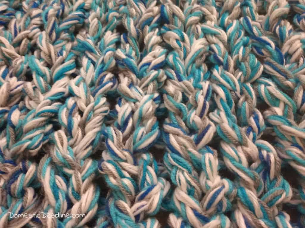 Learn how to turn lots of leftoer yarn into a chunky knit blanket. Customize with any colors to match any decor. Plus stash busting craft blog hop. DomesticDeadline.com