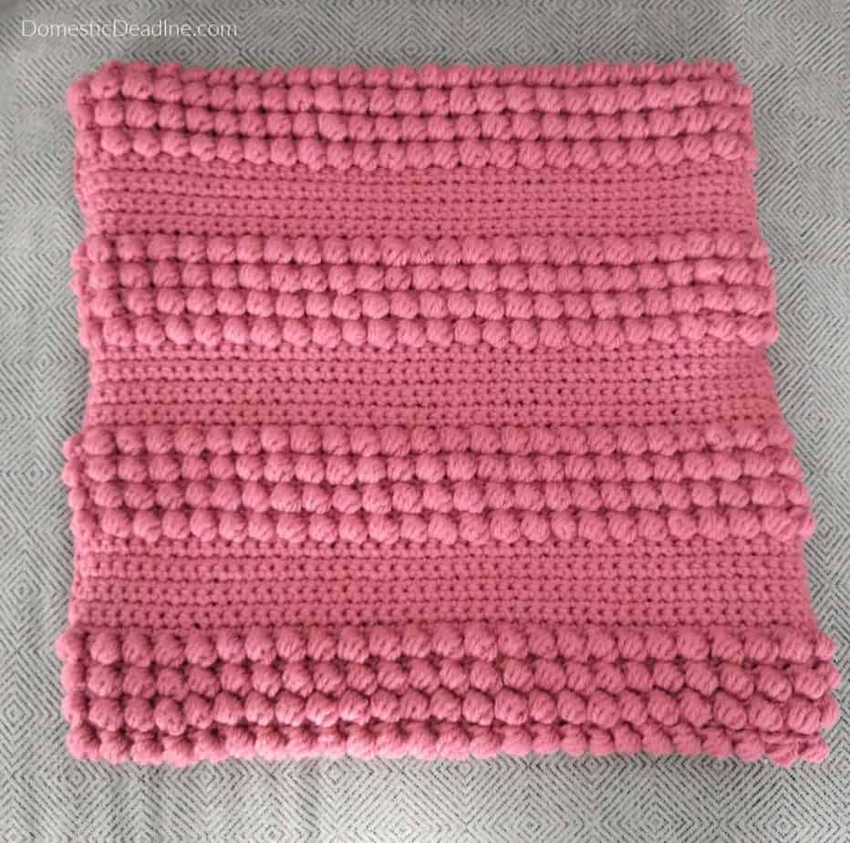 Use this free pattern to crochet your own mid-century modern-inspired pillow cover. Two simple stitches add texture to your decor.